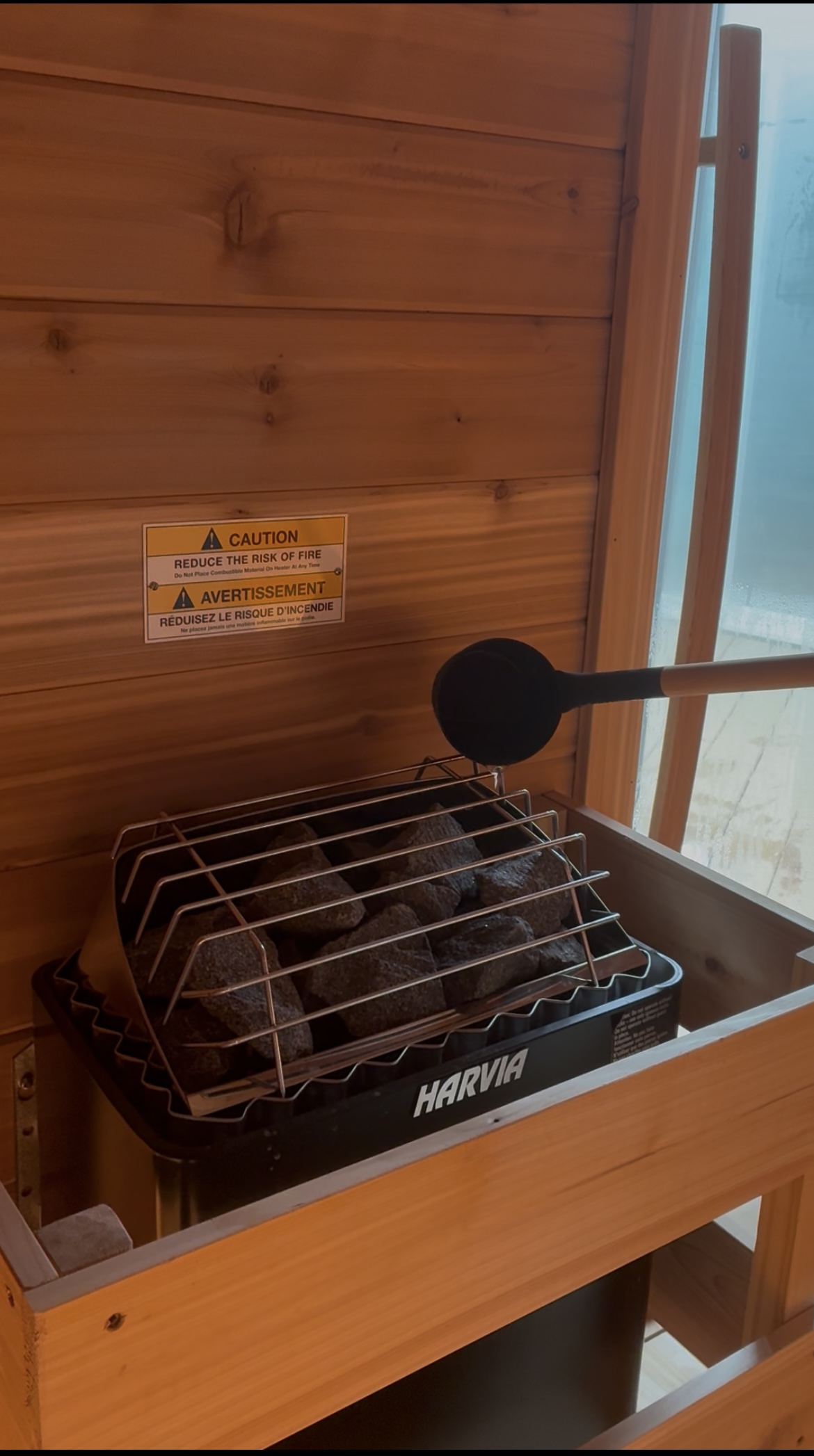 Harvia sauna stove with stones and ladle
